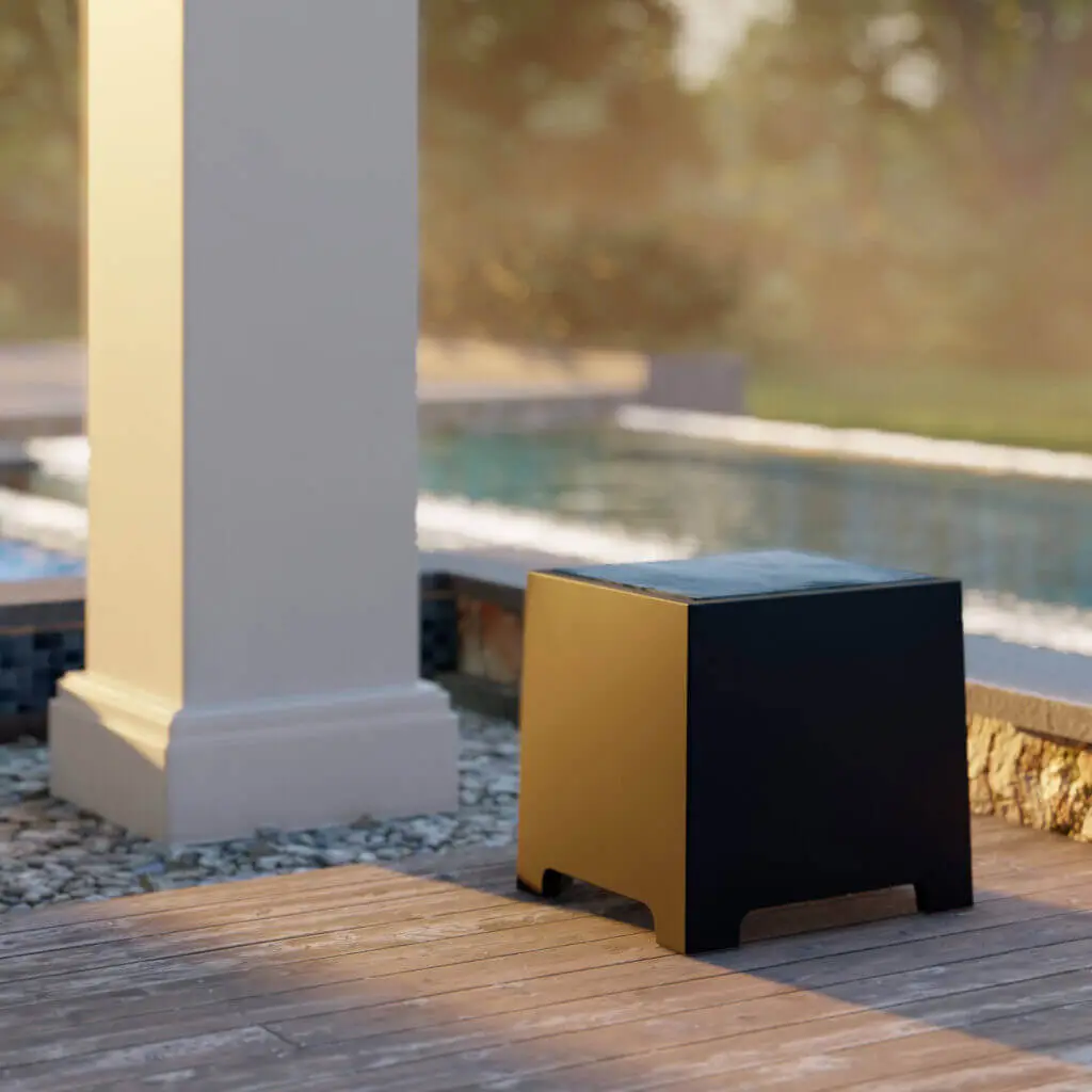 Conscape Lighting + Audio A modern, black and yellow cubic stool sits on wooden decking near a pool, enhanced by subtle outdoor lighting, with a column and greenery in the background.